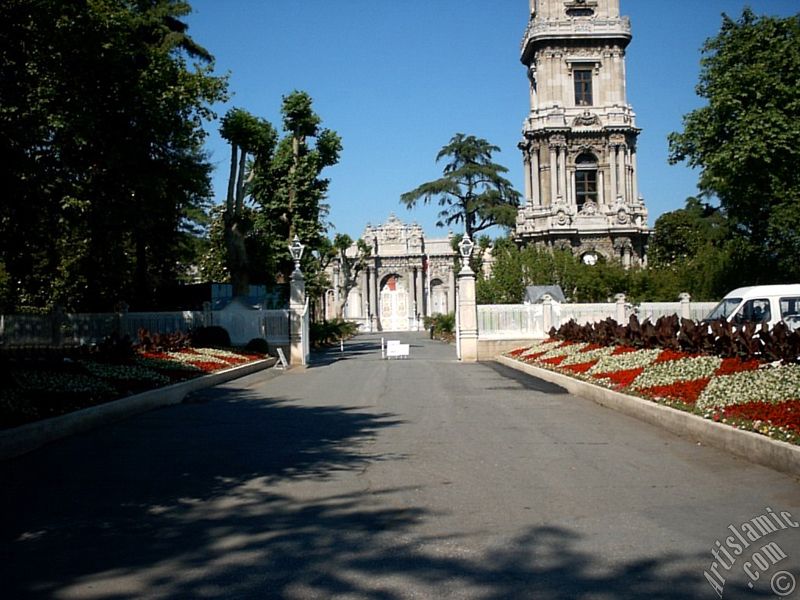 View of Dolmabahce Palace`s entrance and clock tower located in Dolmabahce district in Istanbul city of Turkey.
