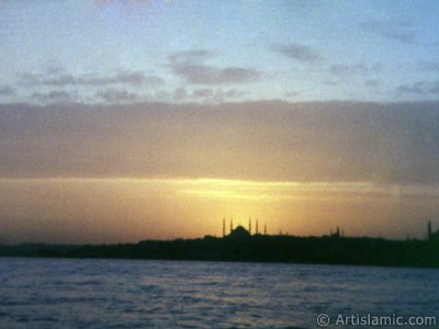 A sunset view of Sarayburnu coast and Sultan Ahmet Mosque (Blue Mosque) from the Bosphorus in Istanbul city of Turkey. The picture was taken by Artislamic.com in 1985 with an old model camera.