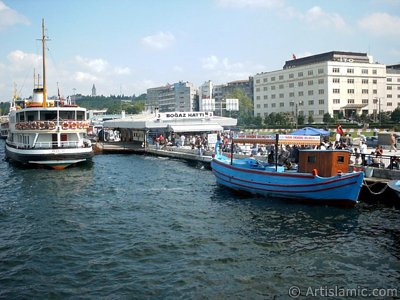 View of Eminonu shore, jetty, ship and fisherman`s boat from the sea in Istanbul city of Turkey. (The picture was taken by Artislamic.com in 2004.)