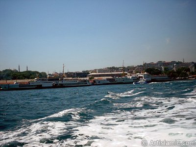 View of Eminonu coast, ships and Ayasofya Mosque (Hagia Sophia) from the sea in Istanbul city of Turkey. (The picture was taken by Artislamic.com in 2004.)