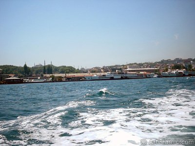 View of Eminonu coast, ships and Ayasofya Mosque (Hagia Sophia) from the sea in Istanbul city of Turkey. (The picture was taken by Artislamic.com in 2004.)
