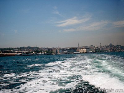 View of Eminonu coast, Beyazit Tower, Yeni Cami (Mosque) and Suleymaniye Mosque from the sea in Istanbul city of Turkey. (The picture was taken by Artislamic.com in 2004.)