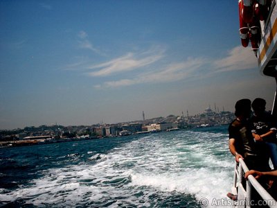 View of Eminonu coast, Beyazit Tower, Yeni Cami (Mosque) and Suleymaniye Mosque from the sea in Istanbul city of Turkey. (The picture was taken by Artislamic.com in 2004.)