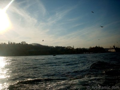 View of Sarayburnu coast, Topkapi Palace, Beyazit Tower and Suleymaniye Mosque from the Bosphorus in Istanbul city of Turkey. (The picture was taken by Artislamic.com in 2004.)