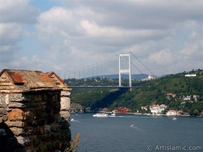 View of the Bosphorus and Fatih Sultan Mehmet Bridge from Rumeli Hisari which was ordered by Sultan Mehmet the Conqueror to be built before conquering Istanbul in 1452 in Turkey. (The picture was taken by Mr. Mustafa one of the visitors of Artislamic.com in 2004)