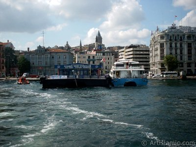 View of the sea bus landed the jetty and at behind above historical Galata Tower from the shore of Karakoy in Istanbul city of Turkey. (The picture was taken by Artislamic.com in 2004.)