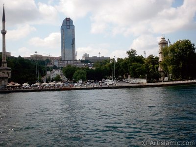 View of Dolmabahce coast, Valide Sultan Mosque and clock tower from the Bosphorus in Istanbul city of Turkey. (The picture was taken by Artislamic.com in 2004.)