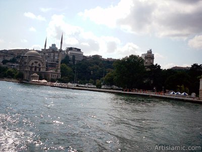 View of Dolmabahce coast, Valide Sultan Mosque and clock tower from the Bosphorus in Istanbul city of Turkey. (The picture was taken by Artislamic.com in 2004.)