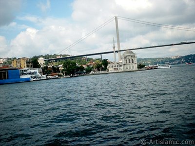 View of Ortakoy coast, Ortakoy Mosque and Bosphorus Bridge from the Bosphorus in Istanbul city of Turkey. (The picture was taken by Artislamic.com in 2004.)