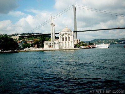 View of Ortakoy coast, Ortakoy Mosque and Bosphorus Bridge from the Bosphorus in Istanbul city of Turkey. (The picture was taken by Artislamic.com in 2004.)