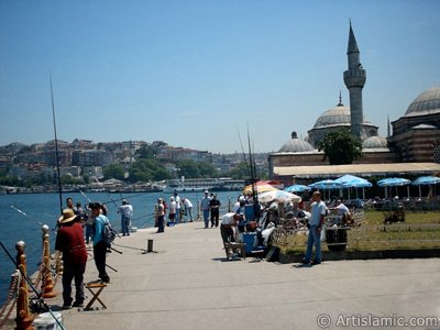 View of fishing people and Semsi Pasha Mosque made by Architect Sinan in Uskudar shore of Istanbul city of Turkey. (The picture was taken by Artislamic.com in 2004.)