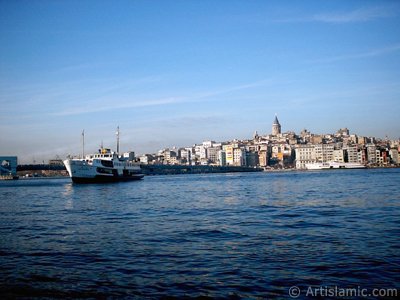 View of a landing ship, Galata Bridge and Galata Tower from the shore of Eminonu in Istanbul city of Turkey. (The picture was taken by Artislamic.com in 2004.)