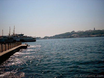 View of Karakoy jetty and Topkapi Palace from the shore of Karakoy in Istanbul city of Turkey. (The picture was taken by Artislamic.com in 2004.)