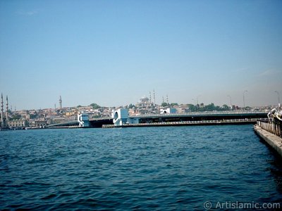 View of Eminonu coast, Yeni Cami (Mosque), (at far behind) Beyazit Mosque, Beyazit Tower, Galata Brigde and Suleymaniye Mosque from Karakoy jetty in Istanbul city of Turkey. (The picture was taken by Artislamic.com in 2004.)