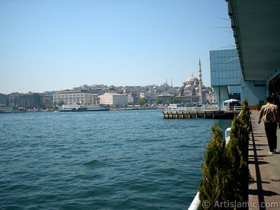 View of Eminonu coast, Sultan Ahmet Mosque (Blue Mosque) and Yeni Cami (Mosque) from under the Galata Bridge in Istanbul city of Turkey. (The picture was taken by Artislamic.com in 2004.)