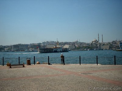 View of fishing man, Eminonu coast, Sultan Ahmet Mosque (Blue Mosque) and Yeni Cami (Mosque) from the shore of Karakoy in Istanbul city of Turkey. (The picture was taken by Artislamic.com in 2004.)