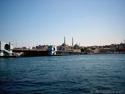 View of Eminonu coast, (from left) Galata Bridge, Yeni Cami (Mosque), Sultan Ahmet Mosque (Blue Mosque) and (below) Egyptian Bazaar (Spice Market) from the shore of Karakoy-Persembe Pazari in Istanbul city of Turkey. (The picture was taken by Artislamic.com in 2004.)
