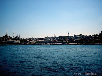 View of Eminonu coast, (from left) Galata Bridge, Yeni Cami (Mosque), Sultan Ahmet Mosque (Blue Mosque), (below) Egyptian Bazaar (Spice Market) and Beyazit Tower from the shore of Karakoy-Persembe Pazari in Istanbul city of Turkey. (The picture was taken by Artislamic.com in 2004.)