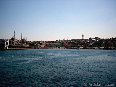 View of Eminonu coast, (from left) Galata Bridge, Yeni Cami (Mosque), Sultan Ahmet Mosque (Blue Mosque), (below) Egyptian Bazaar (Spice Market) and Beyazit Tower from the shore of Karakoy-Persembe Pazari in Istanbul city of Turkey. (The picture was taken by Artislamic.com in 2004.)