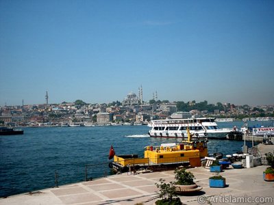 View of Eminonu coast, (from left) Beyazit Tower, (below) Rustem Pasha Mosque and (above) Suleymaniye Mosque from the shore of Karakoy-Persembe Pazari in Istanbul city of Turkey. (The picture was taken by Artislamic.com in 2004.)