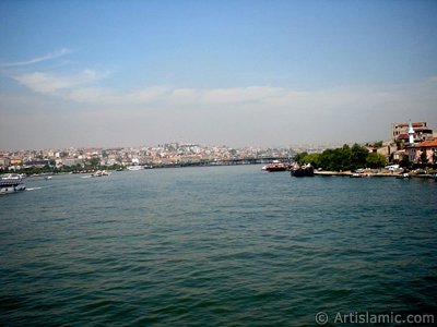 View towards Sarachane coast, on the horizon Yavuz Sultan Selim Mosque and on the right a small mosque from under Galata Bridge located in Istanbul city of Turkey. (The picture was taken by Artislamic.com in 2004.)