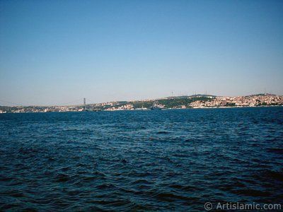 View towards Bosphorus Bridge and Uskudar coast from a park at Kabatas shore in Istanbul city of Turkey. (The picture was taken by Artislamic.com in 2004.)