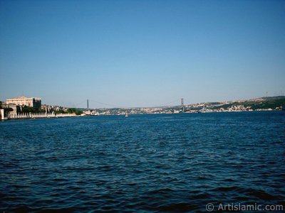 View of the Dolmabahce Palace, Bosphorus Bridge and Uskudar coast from a park at Dolmabahce shore in Istanbul city of Turkey. (The picture was taken by Artislamic.com in 2004.)