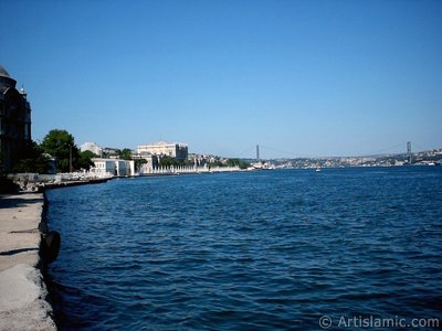 View of the Valide Sultan Mosque, Dolmabahce Palace, Bosphorus Bridge and Uskudar coast from a park at Dolmabahce shore in Istanbul city of Turkey. (The picture was taken by Artislamic.com in 2004.)