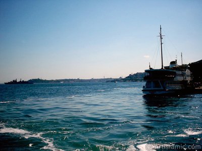 View of a landed ship at jetty and on the horizon Sarayburnu-Eminonu coast from the shore of Besiktas in Istanbul city of Turkey. (The picture was taken by Artislamic.com in 2004.)