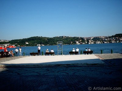 View of fishing people and Uskudar-Beylerbeyi coast on the horizon from a park at Ortakoy shore in Istanbul city of Turkey. (The picture was taken by Artislamic.com in 2004.)