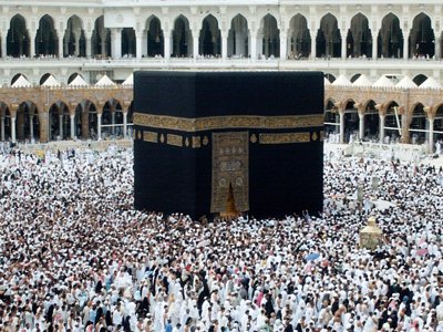 The Holy Kabah, Station of Abraham (golden blond matter on the right), Hicr Esmael (right to Kabah) and the muslims from every counrty circumambulating the Kabah in the Masjed al-Haraam in Mecca city of Saudi Arabia. Because everythings` Creator and Owner Allah (swt) said in the Holy Koran: ``The first House (of worship) appointed for men was that at Bakka; full of blessing and of guidance for all kinds of beings: In it are Signs manifest; (for example), the Station of Abraham; whoever enters it attains security; PILGRIMAGE THERETO IS A DUTY MEN OWE TO ALLAH, those who can afford the journey; but if any deny faith, Allah stands not in need of any of His creatures.`` (3:96,97) (The picture was taken by Mr. Mustafa one of the visitors of Artislamic.com in 2003 Ramadan.)