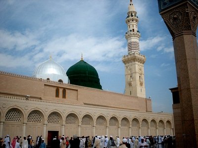 View of the Prophet Muhammad`s (saaw) Mosque (Masjed an-Nabawe) in Madina city of Saudi Arabia. On the area under the green dome there are tombs of the Prophet Muhammad, Abubakr (first caliph of Islam) and Omar (second caliph). At the same time there is home and minbar of the Prophet and ``soffa`` where the poor muslims used to stay and take education in the time of the Prophet. (The picture was taken by Mr. Mustafa one of the visitors of Artislamic.com in 2003 Ramadan.)