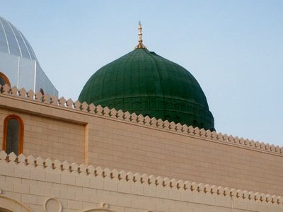 View towards to the green dome (kubbatu`l khadraa) over the Prophet Muhammad`s (saaw) Mosque (Masjed an-Nabawe) in Madina city of Saudi Arabia. On the area under the green dome there are tombs of the Prophet Muhammad, Abubakr (first caliph of Islam) and Omar (second caliph). At the same time there is home and minbar of the Prophet and ``soffa`` where the poor muslims used to stay and take education in the time of the Prophet. (The picture was taken by Mr. Mustafa one of the visitors of Artislamic.com in 2003 Ramadan.)