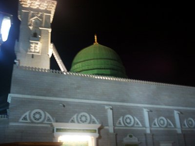 View towards to the green dome (kubbatu`l khadraa) over the Prophet Muhammad`s (saaw) Mosque (Masjed an-Nabawe) in Madina city of Saudi Arabia. On the area under the green dome there are tombs of the Prophet Muhammad, Abubakr (first caliph of Islam) and Omar (second caliph). At the same time there is home and minbar of the Prophet and ``soffa`` where the poor muslims used to stay and take education in the time of the Prophet. (The picture was taken by Mr. Mustafa one of the visitors of Artislamic.com in 2003 Ramadan.)