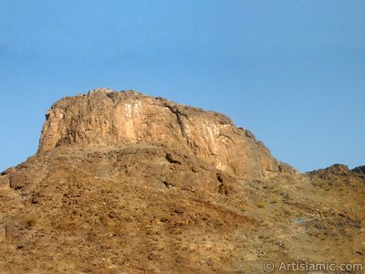 The Mount Hira in Mecca city of Saudi Arabia (el-Cabal en-Nour). Before the Prophet Muhammad (saaw) was charged with the prophethood by Allah (swt) he would go for spiritual retreats to a cave in this mount. This cave is named as Cave Hira and located in the projecting part of the mount on the left-up side. The Prophet Muhammad had received the first Koran verses from our Lord in the Cave Hira on this mount and seen the Angel Gabriel first time in its true form here. The first Koran verses revealed to Him on this mount were these: ``READ! IN THE NAME OF YOUR LORD WHO CREATES. CREATES MAN FROM A CLOT OF BLOOD. READ! AND YOUR LORD IS MOST GENEROUS. WHO TEACHES BY THE PEN. TEACHES MEN THAT WHICH HE KNEW NOT.`` (The Holy Koran: 96:1-5.) (The picture was taken by Mr. Mustafa one of the visitors of Artislamic.com in 2003 Ramadan.)