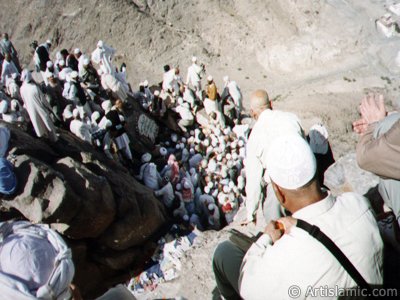 Entrance of the Cave Hira in the Mount Hira in Mecca city of Saudi Arabia and the pilgrims climbing to the mount for entering the cave. Before the Prophet Muhammad (saaw) was charged with the prophethood by Allah (swt) he would go for spiritual retreats to the cave in this mount. The Prophet Muhammad had received the first Koran verses from our Lord in the Cave Hira on this mount and seen the Angel Gabriel first time in its true form here. The first Koran verses revealed to Him on this mount were these: ``READ! IN THE NAME OF YOUR LORD WHO CREATES. CREATES MAN FROM A CLOT OF BLOOD. READ! AND YOUR LORD IS MOST GENEROUS. WHO TEACHES BY THE PEN. TEACHES MEN THAT WHICH HE KNEW NOT.`` (The Holy Koran: 96:1-5.) (The picture was taken by Mr. Mustafa one of the visitors of Artislamic.com in 2003 Hajj season.)