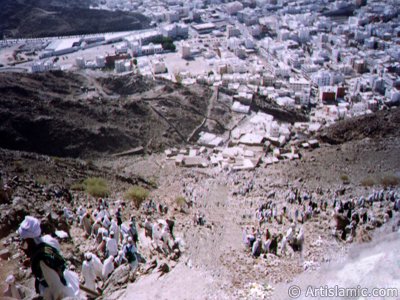 View of the city Mecca from the Mount Hira and the pilgrims climbing to the mount. Before the Prophet Muhammad (saaw) was charged with the prophethood by Allah (swt) he would go for spiritual retreats to a cave called as Cave Hira in this mount. The Prophet Muhammad had received the first Koran verses from our Lord in the Cave Hira on this mount and seen the Angel Gabriel first time in its true form here. The first Koran verses revealed to Him on this mount were these: ``READ! IN THE NAME OF YOUR LORD WHO CREATES. CREATES MAN FROM A CLOT OF BLOOD. READ! AND YOUR LORD IS MOST GENEROUS. WHO TEACHES BY THE PEN. TEACHES MEN THAT WHICH HE KNEW NOT.`` (The Holy Koran: 96:1-5.) (The picture was taken by Mr. Mustafa one of the visitors of Artislamic.com in 2003 Hajj season.)