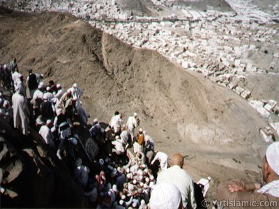 Entrance of the Cave Hira in the Mount Hira in Mecca city of Saudi Arabia and the pilgrims climbing to the mount for entering the cave. Before the Prophet Muhammad (saaw) was charged with the prophethood by Allah (swt) he would go for spiritual retreats to the cave in this mount. The Prophet Muhammad had received the first Koran verses from our Lord in the Cave Hira on this mount and seen the Angel Gabriel first time in its true form here. The first Koran verses revealed to Him on this mount were these: ``READ! IN THE NAME OF YOUR LORD WHO CREATES. CREATES MAN FROM A CLOT OF BLOOD. READ! AND YOUR LORD IS MOST GENEROUS. WHO TEACHES BY THE PEN. TEACHES MEN THAT WHICH HE KNEW NOT.`` (The Holy Koran: 96:1-5.) (The picture was taken by Mr. Mustafa one of the visitors of Artislamic.com in 2003 Hajj season.)