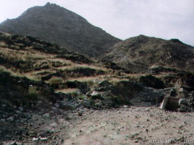 The Mount Savr in Mecca city of Saudi Arabia. The Prophet Muhammed (saaw) and his friend Abu Bakr (ra) had got shut of the Meccan enemies tracking them by hidding three days in a cave in this mount with the great help of Allah (swt). In the Holy Koran our Lord Allah said about the Savr Cave in this mount: ``If ye help not (Muhammad), (it is no matter): for Allah did indeed help him, when the unbelievers drove him out: he had no more than one companion: they two were in the Cave, and he said to his companion, ``Have no fear for Allah is with us``: then Allah sent down His peace upon him, and strengthened him with forces which ye saw not, and humbled to the depths the word of the unbelievers. But the word of Allah is exalted to the heights: for Allah is Exalted in might, Wise.`` (The Holy Koran 9:40). (The picture was taken by Mr. Mustafa one of the visitors of Artislamic.com in 2003 Hajj season.)