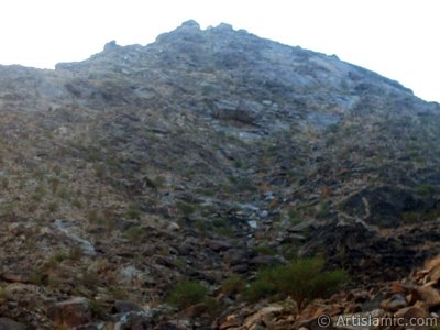 The Mount Savr in Mecca city of Saudi Arabia. The Prophet Muhammed (saaw) and his friend Abu Bakr (ra) had got shut of the Meccan enemies tracking them by hidding three days in a cave in this mount with the great help of Allah (swt). In the Holy Koran our Lord Allah said about the Savr Cave in this mount: ``If ye help not (Muhammad), (it is no matter): for Allah did indeed help him, when the unbelievers drove him out: he had no more than one companion: they two were in the Cave, and he said to his companion, ``Have no fear for Allah is with us``: then Allah sent down His peace upon him, and strengthened him with forces which ye saw not, and humbled to the depths the word of the unbelievers. But the word of Allah is exalted to the heights: for Allah is Exalted in might, Wise.`` (The Holy Koran 9:40). (The picture was taken by Mr. Mustafa one of the visitors of Artislamic.com in 2003 Ramadan.)