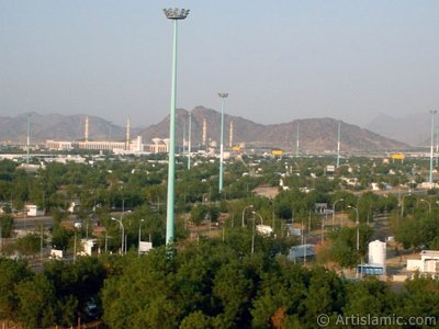 A picture of a part of the Field of Arafah taken from the Hill of Arafah and the Mosque Namira in Mecca city of Saudi Arabia. To be a pilgrim a muslim should stay inside the Field of Arafah in the previous day of the day of Eid Al-Adhaa. (The picture was taken by Mr. Mustafa one of the visitors of Artislamic.com in 2003 Ramadan.)