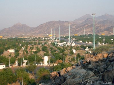 A picture of a part of the Field of Arafah taken from the Hill of Arafah in Mecca city of Saudi Arabia. To be a pilgrim a muslim should stay inside the Field of Arafah in the previous day of the day of Eid Al-Adhaa. (The picture was taken by Mr. Mustafa one of the visitors of Artislamic.com in 2003 Ramadan.)