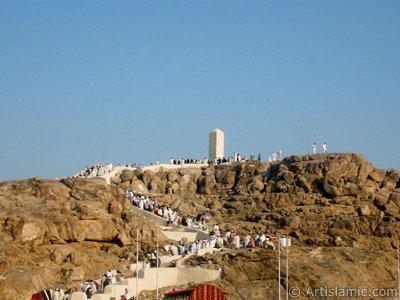 The Hill of Arafah (al-Cabal ar-Rahmah) located in the field of Arafah in Mecca city of Saudi Arabia and the pilgrims visiting these holy places. It is reported that Father Adam and Mother Eve had reunited with each other on this hill after coming into the world from Paradise. (The picture was taken by Mr. Mustafa one of the visitors of Artislamic.com in 2003 Ramadan.)