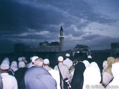 View towards the Mosque of Hadrat Ali (ra) (fourth caliph of Islam) nearby the Prophet Muhammad`s (saaw) Mosque in Madina city of Saudi Arabia. This mosque had been builded by Ottoman and there used to be the home of Hadrat Ali over the place the mosque covers. In the picture, after a morning prayer in a dawn time, you see the sad Turkish pilgrims saying good-bye to these holy places before they return home. (The picture was taken by Mr. Mustafa one of the visitors of Artislamic.com in 2003 Hajj season.)