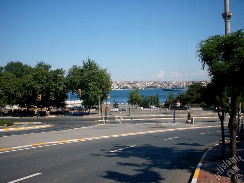 View of Dolmabahce coast and Valide Sultan Mosque`s minaret in Dolmabahce district in Istanbul city of Turkey.
