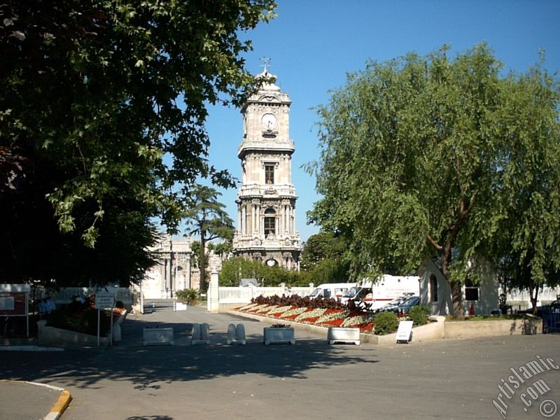 View of Dolmabahce Palace`s entrance and clock tower located in Dolmabahce district in Istanbul city of Turkey.
