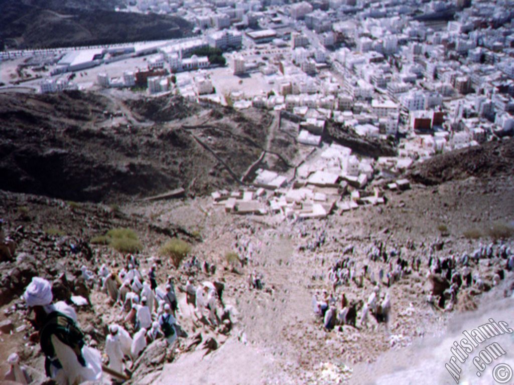 View of the city Mecca from the Mount Hira and the pilgrims climbing to the mount.
